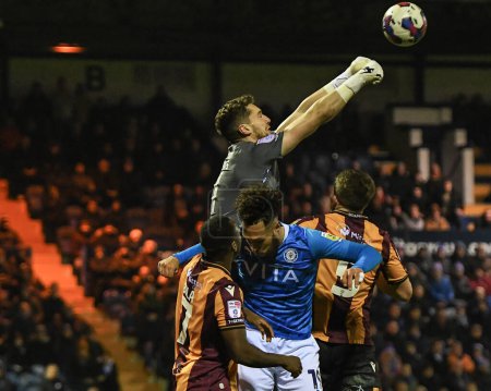 Photo for Harry Lewis #1 of Bradford City punches the ball clear above Kyle Wootton #19 of Stockport County during the Sky Bet League 2 match Stockport County vs Bradford City at Edgeley Park Stadium, Stockport, United Kingdom, 24th January 202 - Royalty Free Image