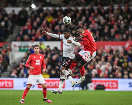 Téléchargez les photos : Tyrell Malacia #12 of Manchester United and Serge Aurier #24 of Nottingham Forest battle for the ball during the Carabao Cup Semi-Finals match Nottingham Forest vs Manchester United at City Ground, Nottingham, United Kingdom, 25th January 202 - en image libre de droit