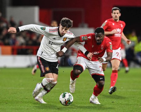 Foto de Alejandro Garnacho #49 of Manchester United and Serge Aurier #24 of Nottingham Forest battle for the ball during the Carabao Cup Semi-Finals match Nottingham Forest vs Manchester United at City Ground, Nottingham, United Kingdom, 25th January 202 - Imagen libre de derechos