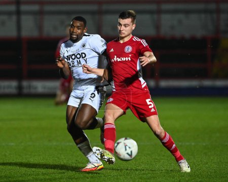 Photo for Lee Ndlovu #9 of Boreham Wood battles for the ball with Ryan Astley #5 of Accrington Stanley during the Emirates FA Cup Third Round Replay match Accrington Stanley vs Boreham Wood at Wham Stadium, Accrington, United Kingdom, 24th January 202 - Royalty Free Image