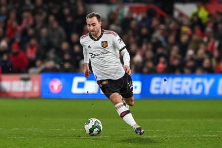 Téléchargez les photos : Christian Eriksen #14 of Manchester United makes a break with the ball during the Carabao Cup Semi-Finals match Nottingham Forest vs Manchester United at City Ground, Nottingham, United Kingdom, 25th January 202 - en image libre de droit