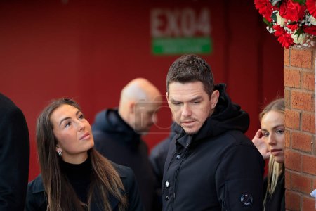 Photo for Womens team captain Katie Zelem looks up at the floral tributes with manager Mark Skinner as Manchester United mark the 65th anniversary of the Munich Air Disaster at Old Trafford, Manchester, United Kingdom, 6th February 2023 - Royalty Free Image