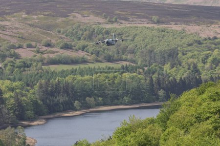 Photo for An RAF A-400 Atlas flys over Derwent Dam on the Dambusters 80th anniversary. The 16th May 2023 marks the 80th anniversary of Operation Chastise, better known as the Dambusters Raid; Derwent Dam, Bamford, United Kingdom - Royalty Free Image