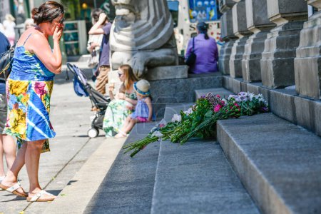 Photo for Nottingham attacks: A member looks at the flowers left on the steps of the the Council House Building in the city centre today after yesterdays attacks which left 3 people dead and 3 injured Nottingham, United Kingdom, 13th June 2023 - Royalty Free Image
