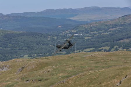 Photo for A Three ship of RAF C-130 Hercules flypast as the Royal Air Force mark the forthcoming retirement of the Hercules in the Mach Loop, Dolgellau, United Kingdom, 13th June 2023 - Royalty Free Image