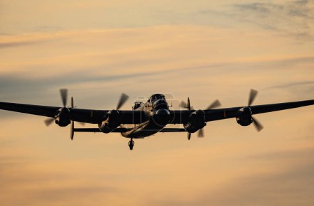 Photo for The Battle of Britain Memorial Flight Lancaster returns to RAF Coningsby after the flypast for Trooping the colour in London - Royalty Free Image