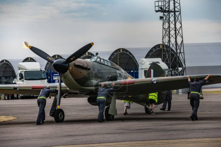 Photo for Ground crew prepare a Hurricane as the Battle of Britain memorial flight and RAF Coningsby typhoon squadrons prepare for the flypast for Trooping the colour at RAF Coningsby, Coningsby, United Kingdom, 17th June 2023 - Royalty Free Image
