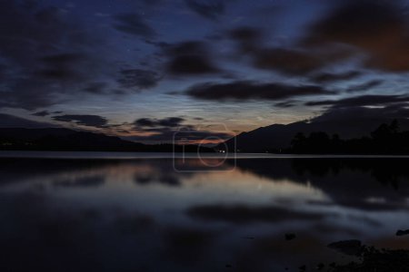 Photo for Noctilucent clouds over Derwentwater on the Summer Solstice near Keswick in the Lake District, Cumbria, United Kingdom, 20th June 2023 - Royalty Free Image