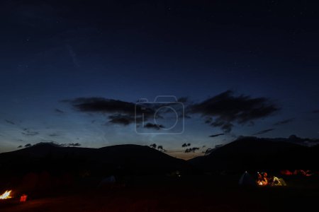 Photo for Noctilucent clouds glow in the night sky over Castlerigg Stone Circle Summer Solstice Celebration, United Kingdom, 20th June 2023 - Royalty Free Image