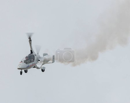 Photo for Peter Davis performs a display with his Autogyro, during Rhyl Air Show 2023 at Rhyl Seafront, Rhyl, United Kingdom, 27th August 2023 - Royalty Free Image