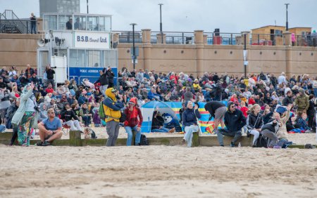 Photo for The crowd watches on the show, during Rhyl Air Show 2023 at Rhyl Seafront, Rhyl, United Kingdom, 27th August 2023 - Royalty Free Image