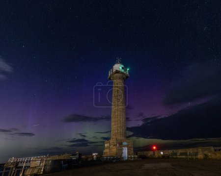 Photo for Aurora Borealis also know as the Northern Lights dazzles the North Yorkshire coastline at Whitby Harbour, Whitby, United Kingdom, 18th September 2023 - Royalty Free Image