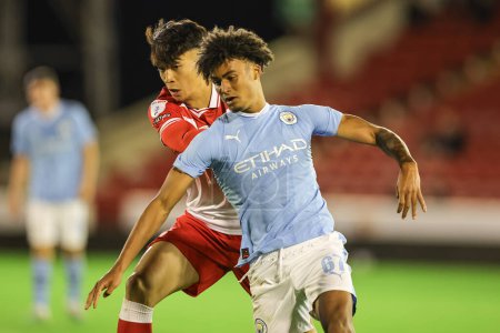 Photo for Nathan James #37 of Barnsley and Kane Taylor #67 of Manchester City U21 battle for the ball during the EFL Trophy match Barnsley vs Manchester City U21 at Oakwell, Barnsley, United Kingdom, 26th September 2023 - Royalty Free Image