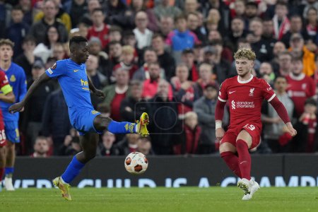 Photo for Harvey Elliott #19 of Liverpool crosses the ball under pressure from , Jean Thierry Lazare Amani during the UEFA Europa League match Liverpool vs Union Saint-Gilloise at Anfield, Liverpool, United Kingdom, 5th October 202 - Royalty Free Image
