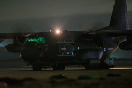 Photo for A USAF C130 Hercules, out of RAF Mildenhall lands on Pembrey Beach, a first for USAF, Controlled by ground crews from Mildenhall and supervised by RAF Brize Norton crews, landings were 00:00 to 01:40 at Pembrey Beach, Pembrey, United Kingdom, 16th Oc - Royalty Free Image