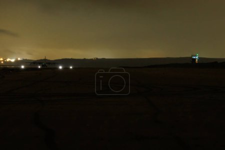 Photo for A USAF C130 Hercules, out of RAF Mildenhall lands on Pembrey Beach, a first for USAF, Controlled by ground crews from Mildenhall and supervised by RAF Brize Norton crews, landings were 00:00 to 01:40 at Pembrey Beach, Pembrey, United Kingdom, 16th Oc - Royalty Free Image