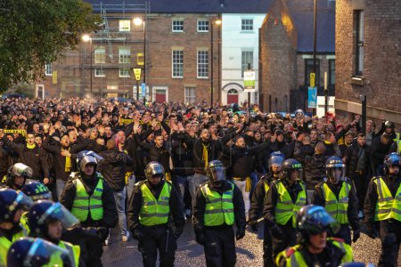 Photo for Borussia Dortmund fans arrive surrounded by riot police the UEFA Champions League match Newcastle United vs Borussia Dortmund at St. James's Park, Newcastle, United Kingdom, 25th October 2023 - Royalty Free Image