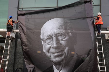 Photo for Workmen erect a tribute to the late Sir Bobby Charlton outside of Old Trafford, Manchester, United Kingdom, 23rd October 2023 - Royalty Free Image