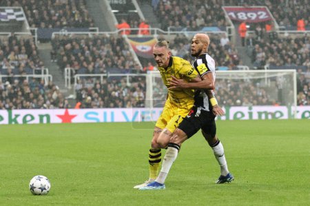 Photo for Marius Wolf #17 of Borussia Dortmund and Joelinton #7 of Newcastle United battle for the ball during the UEFA Champions League match Newcastle United vs Borussia Dortmund at St. James's Park, Newcastle, United Kingdom, 25th October 2023 - Royalty Free Image