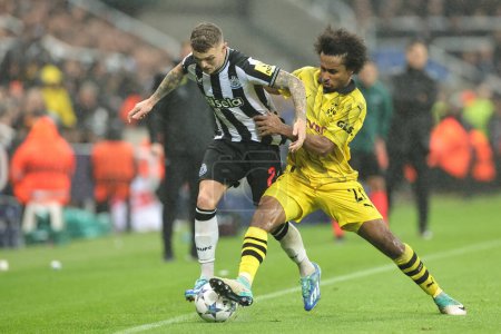 Photo for Karim Adeyemi #27 of Borussia Dortmund and Kieran Trippier #2 of Newcastle United battle for the ball during the UEFA Champions League match Newcastle United vs Borussia Dortmund at St. James's Park, Newcastle, United Kingdom, 25th October 2023 - Royalty Free Image