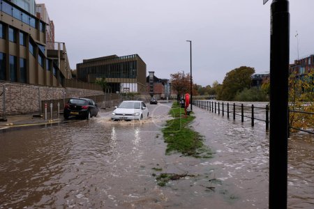 Téléchargez les photos : Des voitures traversent les eaux de crue alors que la rivière Wear éclate sur ses berges et que des inondations éclatent à River Wear, Durham, Royaume-Uni, le 29 octobre 2023 - en image libre de droit