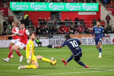 Photo for Viktor Johansson #1 of Rotherham United saves a shot from Crysencio Summerville #10 of Leeds United during the Sky Bet Championship match Rotherham United vs Leeds United at New York Stadium, Rotherham, United Kingdom, 24th November 2023 - Royalty Free Image