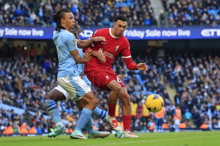 Photo for Trent Alexander-Arnold #66 of Liverpool and Nathan Ake #6 of Manchester City challenge for the ball during the Premier League match Manchester City vs Liverpool at Etihad Stadium, Manchester, United Kingdom, 25th November 2023 - Royalty Free Image