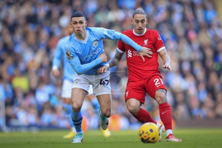 Photo for Phil Foden #47 of Manchester City  tries to get past Kostas Tsimikas #21 of Liverpool during the Premier League match Manchester City vs Liverpool at Etihad Stadium, Manchester, United Kingdom, 25th November 2023 - Royalty Free Image