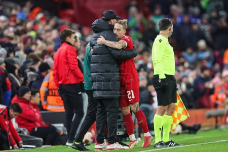 Photo for Jrgen Klopp Manager of Liverpool embraces Kostas Tsimikas #21 of Liverpool as he leaves the field during the UEFA Europa League Group E match Liverpool vs LASK at Anfield, Liverpool, United Kingdom, 30th November 2023 - Royalty Free Image