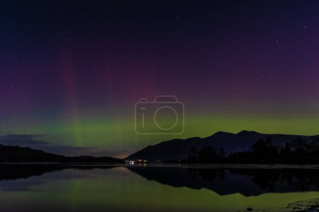 Photo for Northern Lights also know as the Aurora Borealis shine across the Lake District at Derwent Water, Keswick, United Kingdom, 1st December 2023 - Royalty Free Image