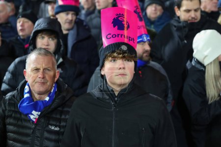 Photo for Everton fans holding up Premier League corrupt posters during the Premier League match Nottingham Forest vs Everton at City Ground, Nottingham, United Kingdom, 2nd December 2023 - Royalty Free Image