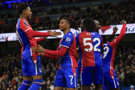 Photo for Michael Olise #7 of Crystal Palace is embraced by Matheus Franca #11 of Crystal Palace after scoring a penalty to make it 2-2 during the Premier League match Manchester City vs Crystal Palace at Etihad Stadium, Manchester, United Kingdom, 16th Decemb - Royalty Free Image