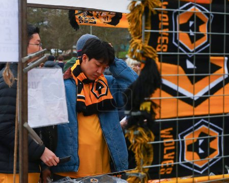 Photo for Wolverhampton Wanderers fans buy merchandise ahead of the match, during the Premier League match Wolverhampton Wanderers vs Chelsea at Molineux, Wolverhampton, United Kingdom, 24th December 202 - Royalty Free Image