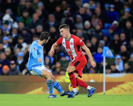 Photo for Luke Thomas of Sheffield United and Bernardo Silva of Manchester City battle for the ball, during the Premier League match Manchester City vs Sheffield United at Etihad Stadium, Manchester, United Kingdom, 30th December 202 - Royalty Free Image