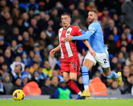 Photo for Kyle Walker of Manchester City and Luke Thomas of Sheffield United battle for the ball, during the Premier League match Manchester City vs Sheffield United at Etihad Stadium, Manchester, United Kingdom, 30th December 202 - Royalty Free Image