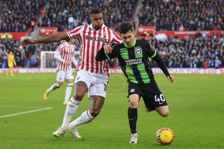 Photo for Wesley of Stoke City and Facundo Buonanotte of Brighton & Hove Albion challenge for the ball during the Emirates FA Cup Third Round match Stoke City vs Brighton and Hove Albion at Bet365 Stadium, Stoke-on-Trent, United Kingdom, 6th January 202 - Royalty Free Image