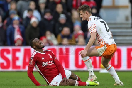 Photo for Callum Connolly of Blackpool fouls Wayne Hennessey of Nottingham Forest during the Emirates FA Cup  Third Round match Nottingham Forest vs Blackpool at City Ground, Nottingham, United Kingdom, 7th January 202 - Royalty Free Image