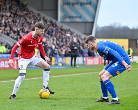 Photo for Ryan Barnett of Wrexham holds the ball up while under pressure from Joe Anderson of Shrewsbury Town, during the Emirates FA Cup Third Round match Shrewsbury Town vs Wrexham at Croud Meadow, Shrewsbury, United Kingdom, 7th January 202 - Royalty Free Image