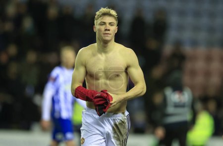 Photo for Rasmus Hojlund of Manchester United takes his shirt to a fan at the end of the Emirates FA Cup Third Round match Wigan Athletic vs Manchester United at DW Stadium, Wigan, United Kingdom, 8th January 202 - Royalty Free Image