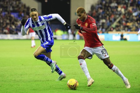 Photo for Marcus Rashford of Manchester United runs past Sean Clare of Wigan Athletic during the Emirates FA Cup Third Round match Wigan Athletic vs Manchester United at DW Stadium, Wigan, United Kingdom, 8th January 202 - Royalty Free Image