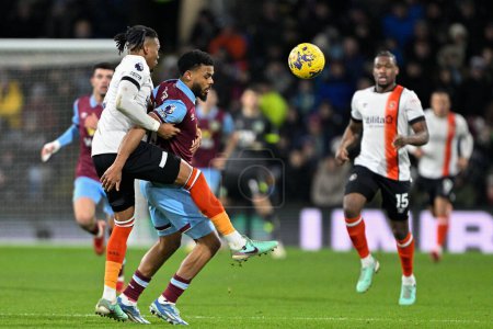 Photo for Gabriel Osho of Luton Town and Lyle Foster of Burnley battle for the ball during the Premier League match Burnley vs Luton Town at Turf Moor, Burnley, United Kingdom, 12th January 2024 - Royalty Free Image