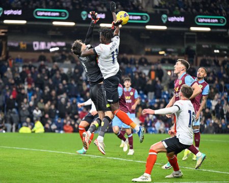Photo for James Trafford of Burnley and Elijah Adebayo of Luton Town battle for the ball during the Premier League match Burnley vs Luton Town at Turf Moor, Burnley, United Kingdom, 12th January 2024 - Royalty Free Image