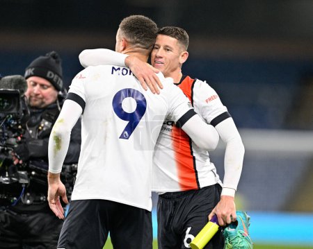 Photo for Carlton Morris of Luton Town and Ross Barkley of Luton Town embrace following a TV interview, during the Premier League match Burnley vs Luton Town at Turf Moor, Burnley, United Kingdom, 12th January 2024 - Royalty Free Image