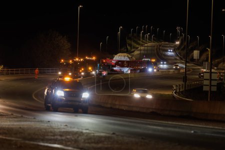 Photo for Hirwaun Power, Drax, transport a 700 ton Heavy goods vehicle along with a police escort on the A456 near Llanelli Hill as part of works to build a new gas powered power station. United Kingdom, 15th January 2024 - Royalty Free Image