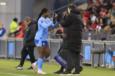 Photo for Khadija Shaw of Manchester City gives a high five to Gareth Taylor the Manchester City manager as she is substituted during the The FA Women's Super League match Manchester City Women vs Liverpool Women at Joie Stadium, Manchester, United Kingdom, 21 - Royalty Free Image