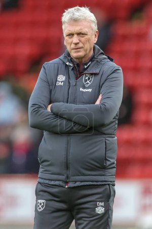 Photo for David Moyes manager of West Ham United watches his team warm up during the Premier League match Sheffield United vs West Ham United at Bramall Lane, Sheffield, United Kingdom, 21st January 202 - Royalty Free Image