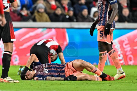 Photo for Nicols Domnguez of Nottingham Forest goes down with a head injury during the Premier League match Brentford vs Nottingham Forest at The Gtech Community Stadium, London, United Kingdom, 20th January 2024 - Royalty Free Image