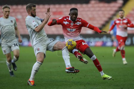 Photo for Devante Cole of Barnsley and Pierce Sweeney of Exeter City battle for the ball during the Sky Bet League 1 match Barnsley vs Exeter City at Oakwell, Barnsley, United Kingdom, 27th January 202 - Royalty Free Image