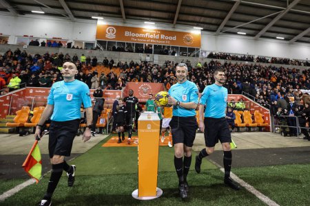 Photo for Referee Seb Stockbridge picks up the match ball as players head out for kickoff during the Bristol Street Motors Trophy Quarter Final match Blackpool vs Bolton Wanderers at Bloomfield Road, Blackpool, United Kingdom, 30th January 202 - Royalty Free Image
