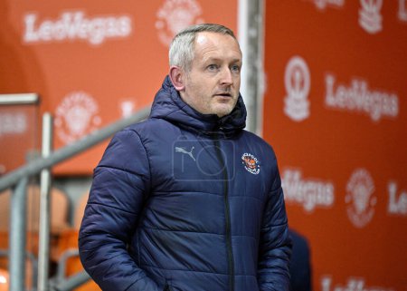 Photo for Neil Critchley Head Coach of Blackpool takes his seat ahead of kick off, during the Bristol Street Motors Trophy Quarter Final match Blackpool vs Bolton Wanderers at Bloomfield Road, Blackpool, United Kingdom, 30th January 202 - Royalty Free Image